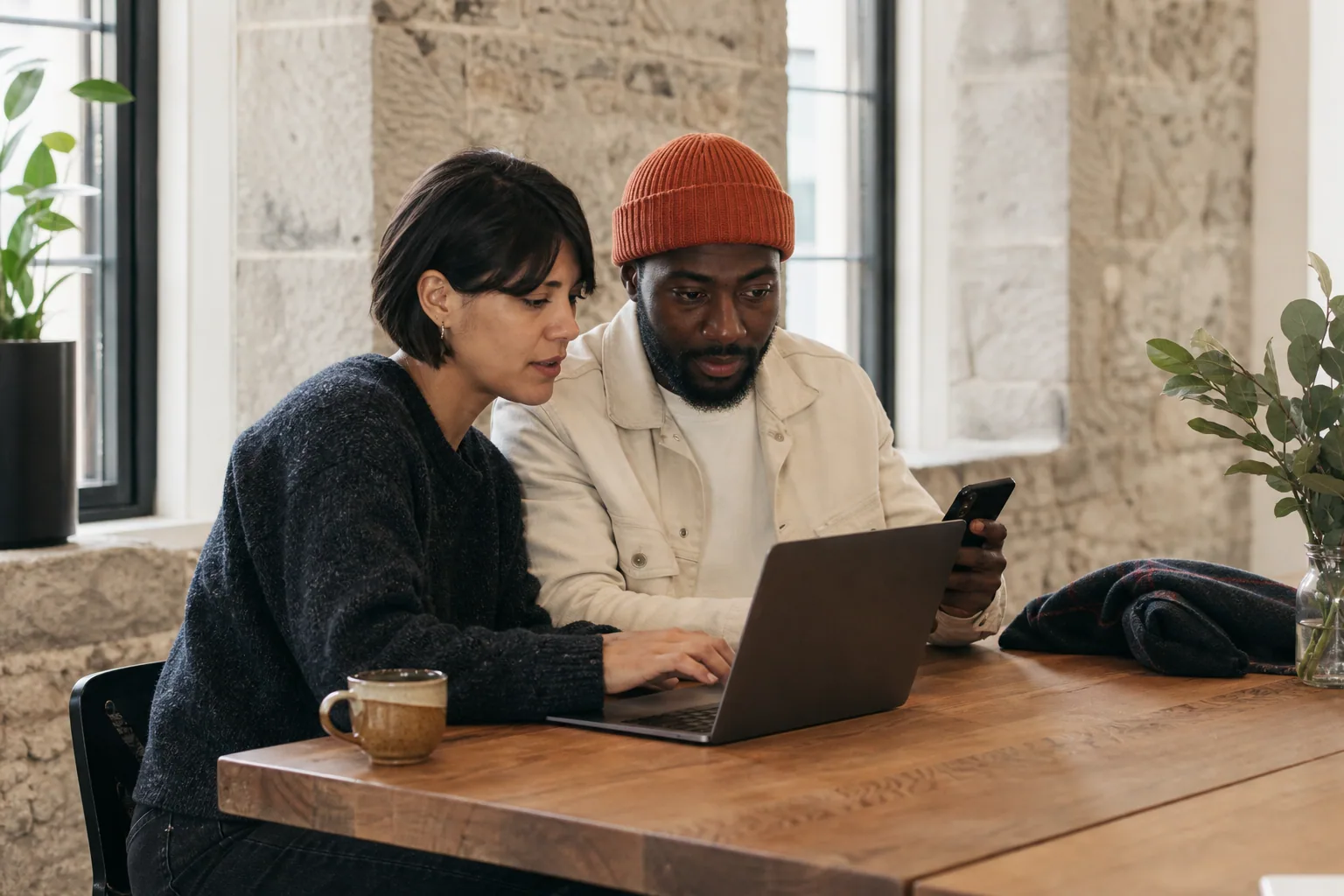 Different customers using accessible website controls on phones and laptops