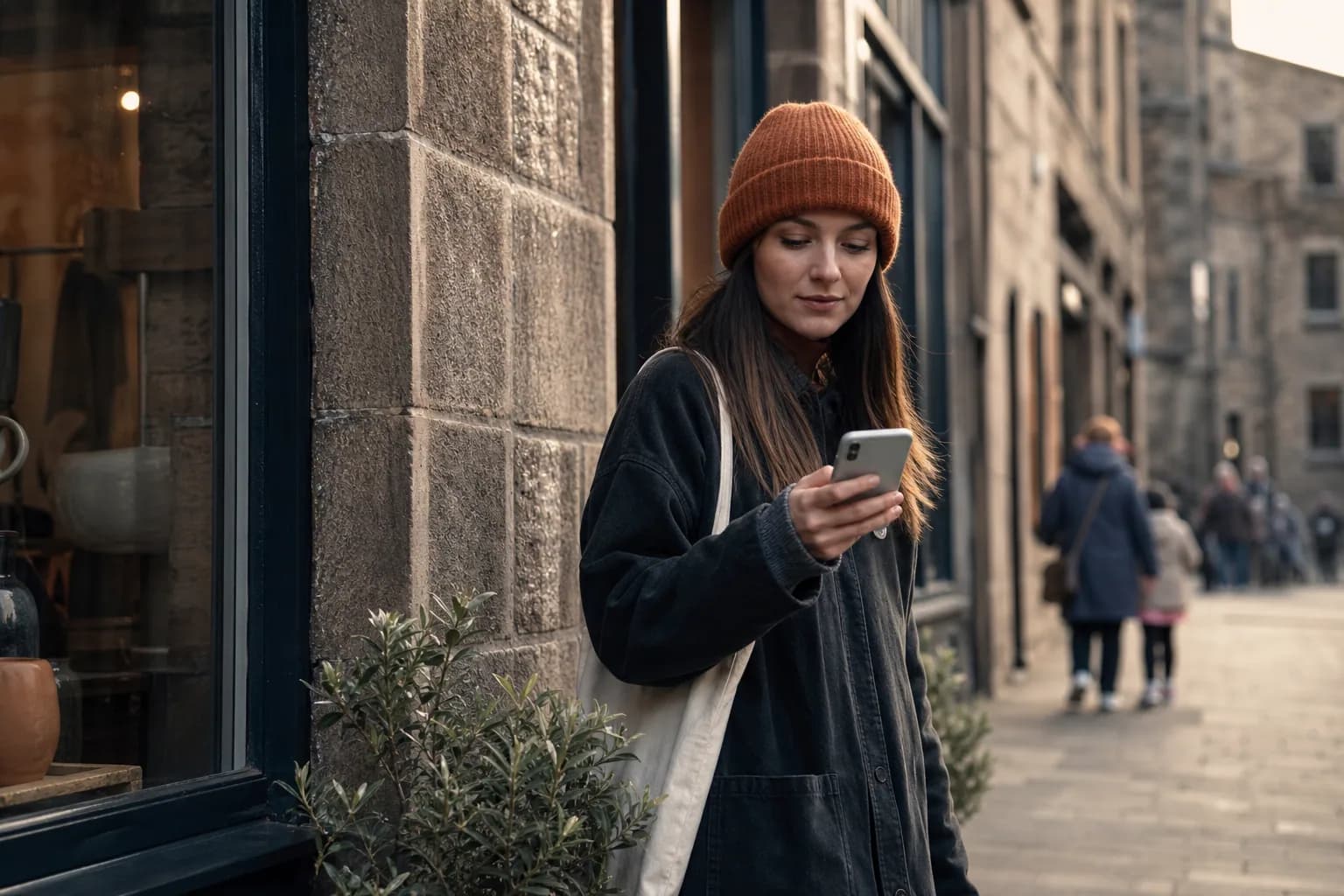 Customer using a clear local-business website on a phone in a Scottish town