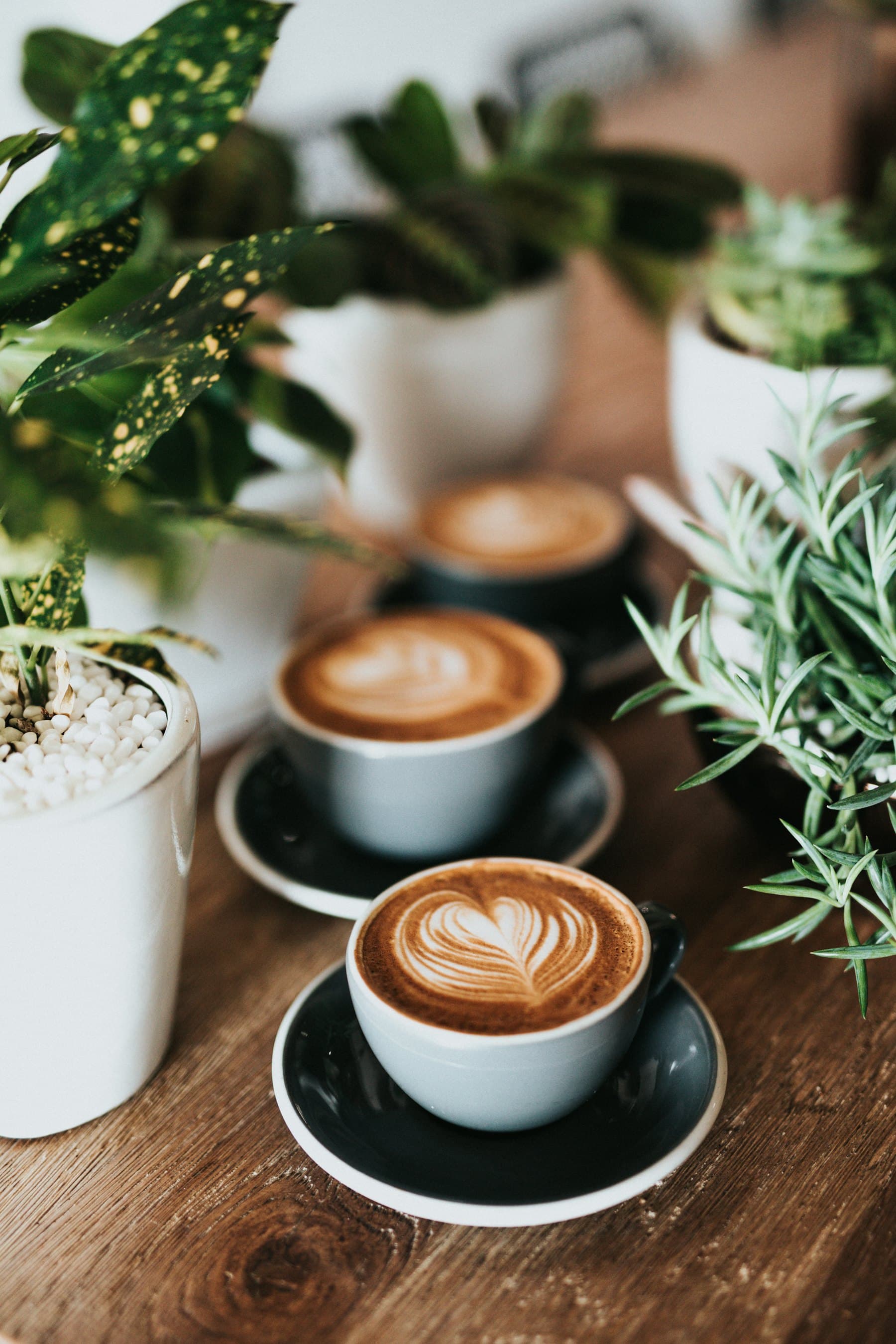 Two cappuccinos on a wooden table