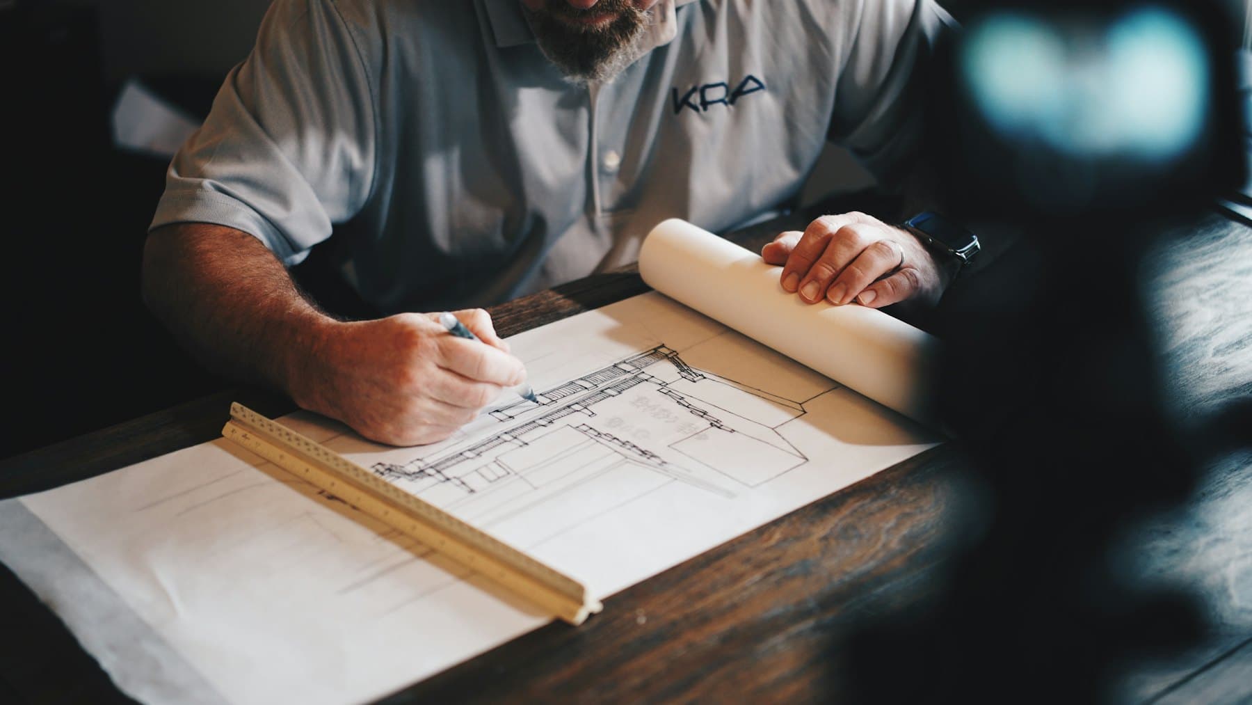 Drawings and hand tools on a workbench